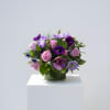 A compact, romantic bouquet of purple blooms that reads like a soft