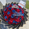 Red and blue rose bouquet with a jeweled crown and birthday topper