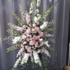 Tall pink and white floral standing spray on an easel