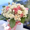 A dense, rounded cluster of garden roses, classic roses, and spray roses