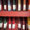 Assorted taper candles in a red display shelf