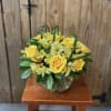 Yellow roses and pale yellow alstroemeria in a glass vase