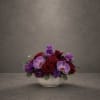 Deep purple accents and two lavender Phalaenopsis orchids take center stage in