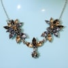 A vintage-inspired, bouquet-shaped pendant that reads like an antique floral arrangement for