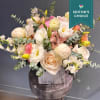 Soft pastel and white flowers, peonies are mixed together in a low