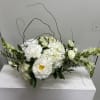 Soft white peonies, clustered hydrangeas, and classic roses come together in a