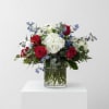 Deep red roses paired with a full cluster of white hydrangeas and