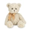 Cream-colored plush teddy bear with a golden satin bow sitting upright.