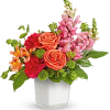 Colorful bouquet of roses and snapdragons in a white vase