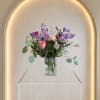 A collection of pastel flowers in this arrangement designed in a beautiful