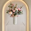 Luxurious arrangement loaded with fresh flowers in soft pinks  
