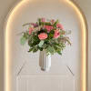 Soft tulips, ruffled carnations, and blush roses create a gentle, garden fresh