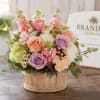 Pastel roses take center stage in this compact, rounded flower arrangement-perfect as