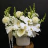 A serene sculptural display of white blooms, Angel's Embrace is a formal
