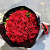 Bouquet of red roses wrapped in black and white paper