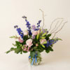 Pale pink roses meet vivid blue delphinium in a fresh, airy arrangement