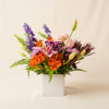 Bright orange alstroemeria and soft pink roses make a joyful first impression