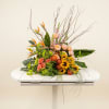 Bright yellow sunflowers and peach roses create a sunlit focal point in