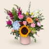 A single, bold sunflower anchors a lively mixed-color bouquet that feels like
