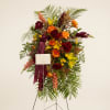 A tall, dignified standing spray that brings warmth and honor to a