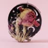 A single preserved rose head, faded pink and red with delicate beige