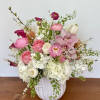 Pink and white mixed flower arrangement in a white vase