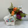 A burst of playful color-orange and deep red roses meet pale blue