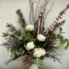 White roses and a single white hydrangea take center stage in this