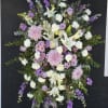 Dense pink lilies and clusters of red and blush roses create the