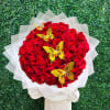 Round bouquet of red roses with yellow butterfly accents