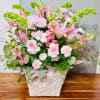 Pink lilies and soft pink-and-white carnations create a gentle, cheerful statement in
