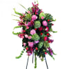 Tall standing floral spray with pink, red, and green blooms