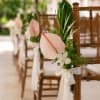 Floral chair adornments add an intentional layer of beauty to the ceremony