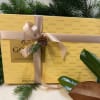 Gift box of Godiva assorted chocolates tied with a ribbon and pine sprig