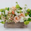 Peach roses and white flowers in a wooden box