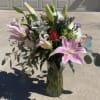 This large beautiful flower arrangement has stargazer lilies, roses, carnations and daisies