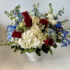 Large white hydrangea clusters set a soft, cloud-like backdrop for deep red
