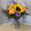 A bold yellow sunflower takes center stage in this cheerful flower arrangement-perfect