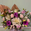 Mixed bouquet with pink and white flowers in a marble-patterned box