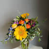 This beautiful flower arrangement of fresh mixed seasonal blooms is made by