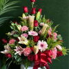 15 red roses with pink gerber daisies, pink carnations, lilies, all nestled