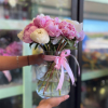 A rounded cluster of 12 pink and white peonies arranged in a