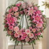 A large, circular sympathy wreath that reads like a tender embrace-Our Hearts