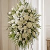 A serene cascade of white lilies, roses, hydrangeas and carnations makes a