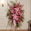 A tall, graceful standing spray that speaks with soft sympathy and tender