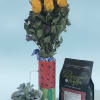 Bright yellow roses clustered upright in a painted watermelon-style ceramic mug make