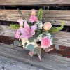 Soft pink, green and white arrangement featuring hydrangea, roses, bells of Ireland