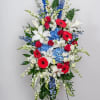 A tall, fan‑shaped standing spray that commands attention with a patriotic palette-perfect