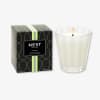 Scented candle in a glass holder beside its box