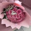 Pink rose bouquet with white baby's breath in pink wrapping